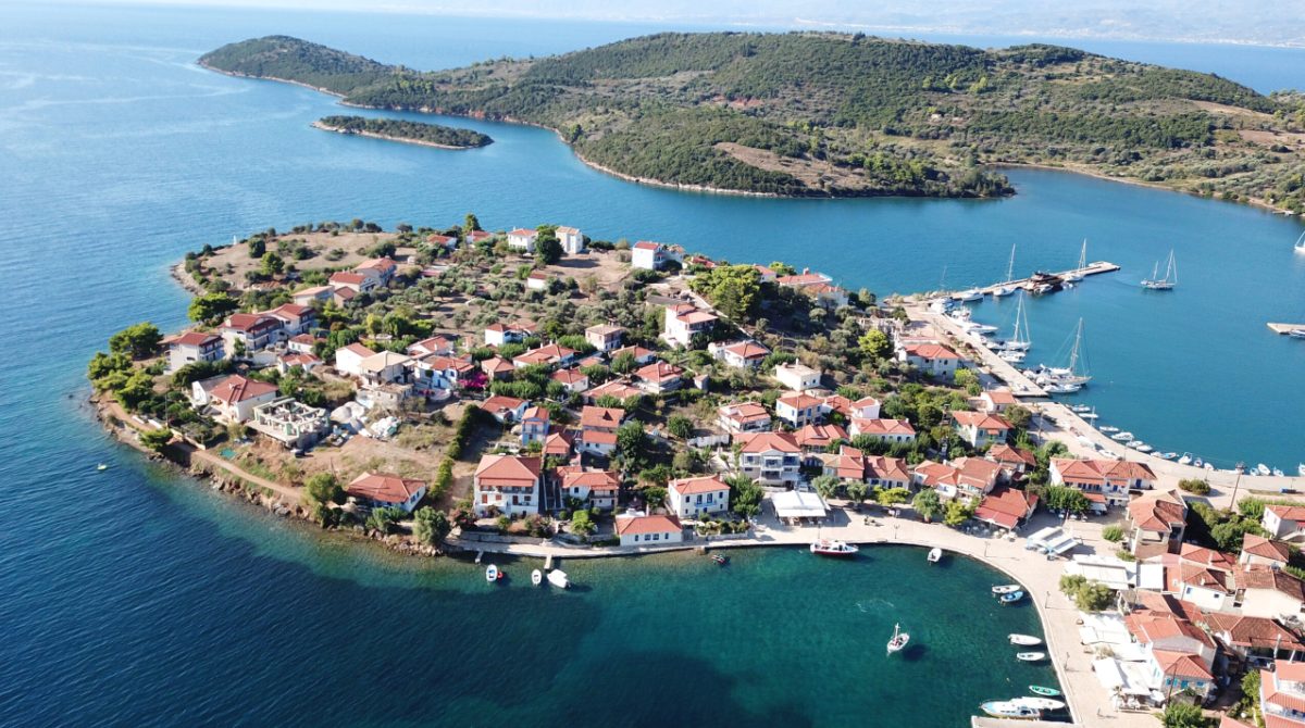 Aerial drone photo of the one and only inhabited island in the Corinthian gulf called Trizonia with natural beauty and small safe port, Greece